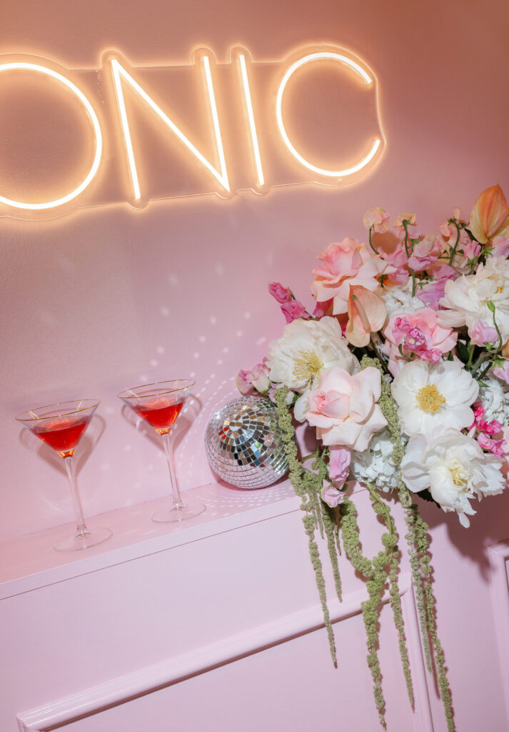 Glamorous pink cocktail setup with florals, disco ball, and neon sign — the perfect moodboard to say it’s time for a visual rebrand, captured by Greenville South Carolina portrait photographer Dani Lacey.