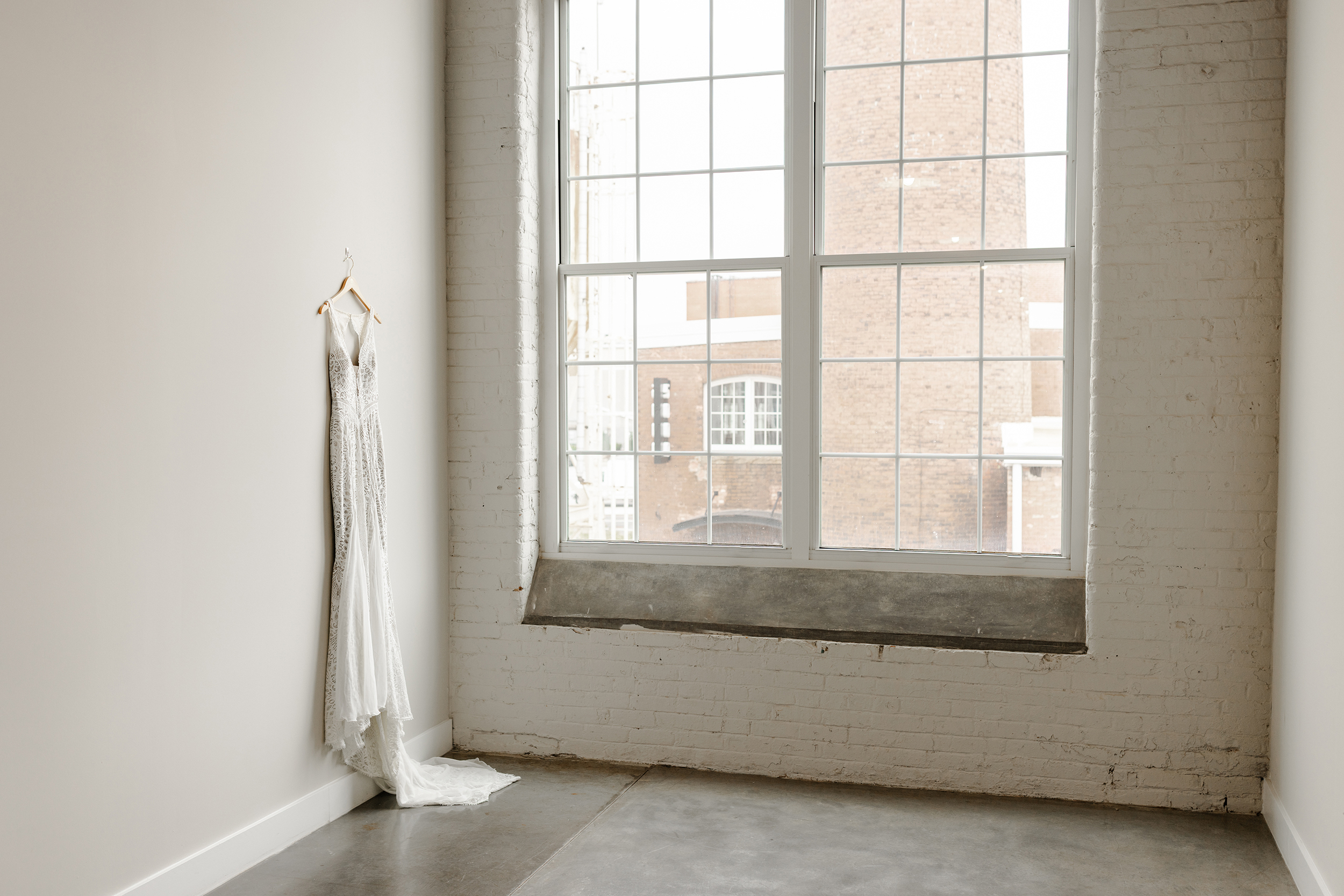A lace wedding dress hangs in a peaceful Greenville SC venue, Dani Lacey Photographs