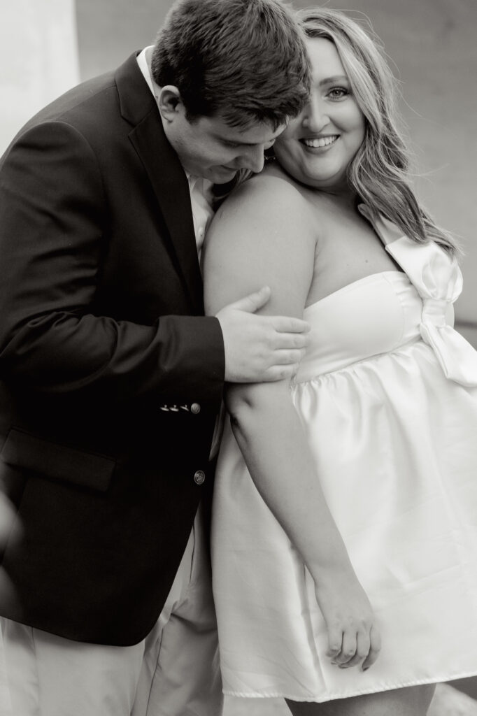 Black and white close-up of couple laughing and embracing during their Falls Park engagement session in Greenville, SC. Dani Lacey Photographs.