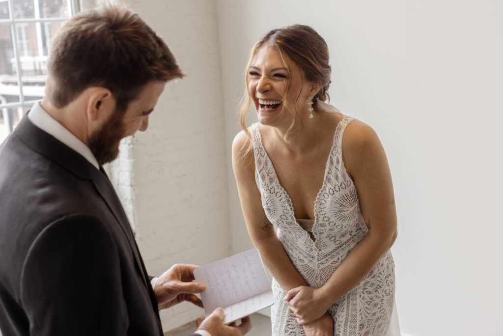 Bride laughing joyfully while the groom reads personal vows — a relaxed, candid wedding day moment that reflects how to actually enjoy your day. Greenville, South Carolina wedding by Dani Lacey Photographs.