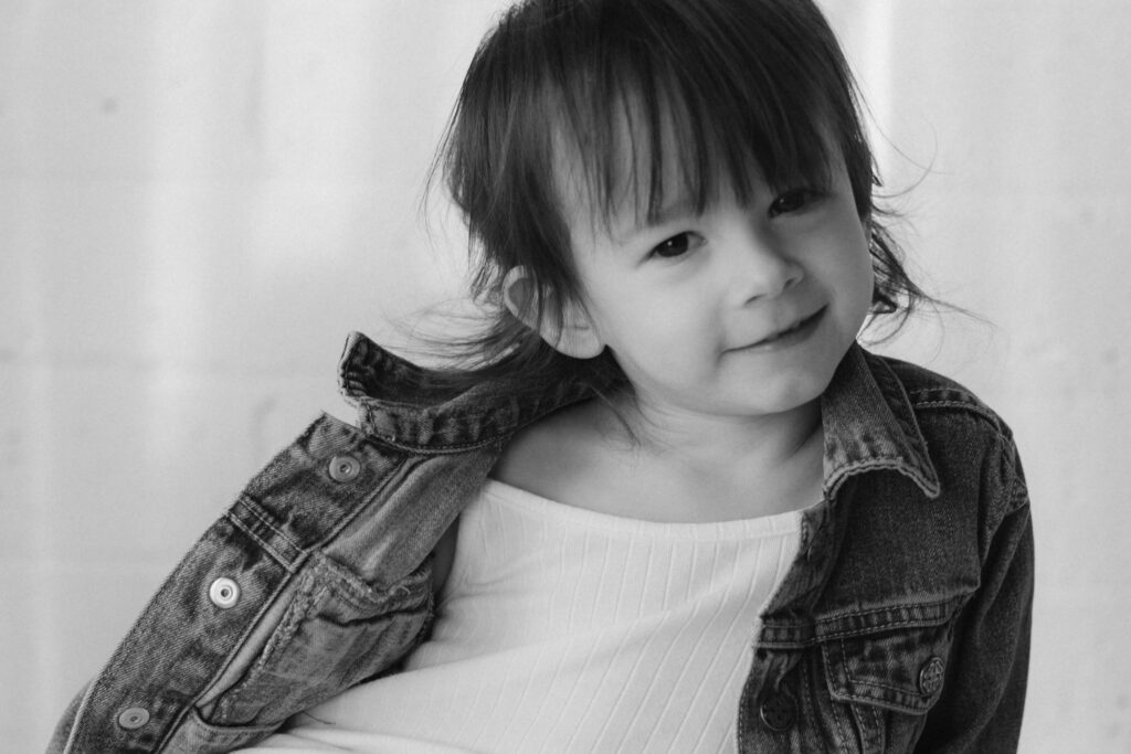 A young girl smiles confidently in a jean jacket and white top Dani Lacey in South Carolina.