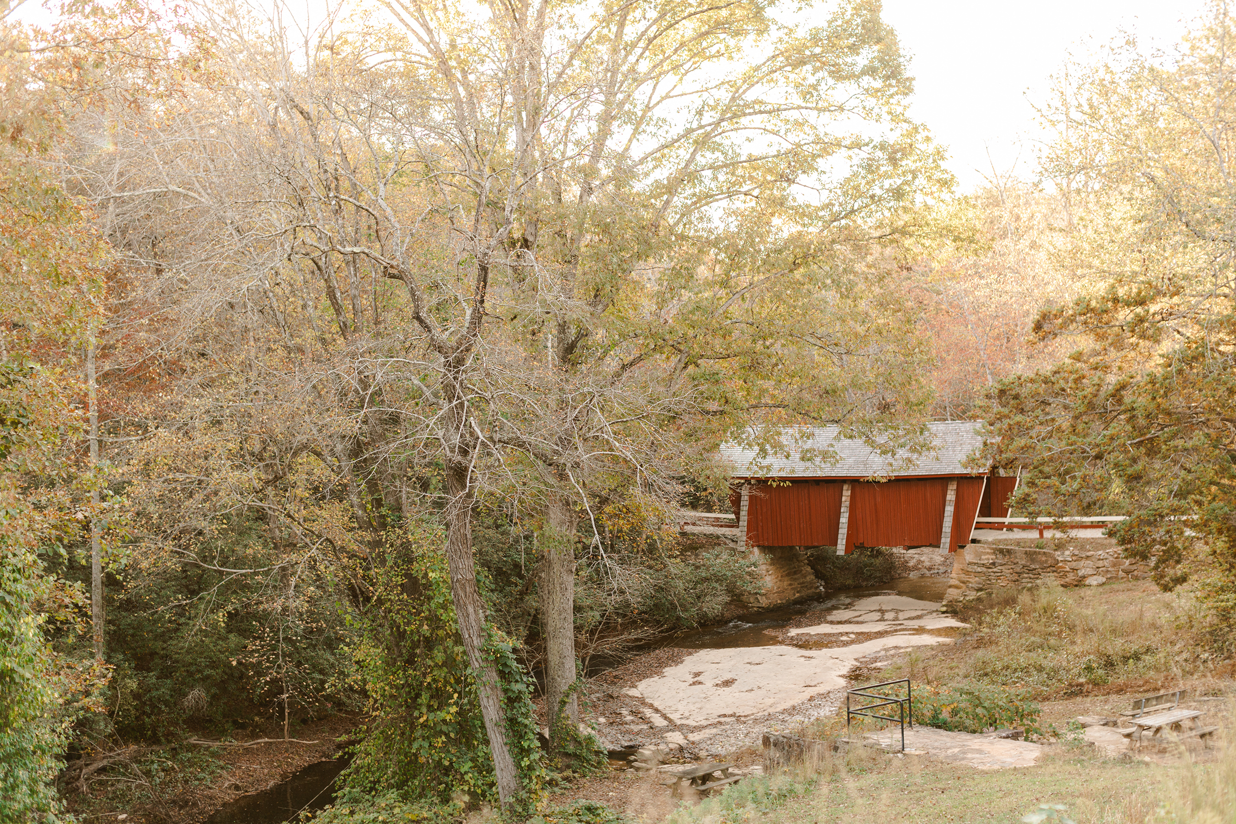 Wide view of Campbell’s Covered Bridge surrounded by fall foliage during peak autumn colors. Dani Lacey Photographs.