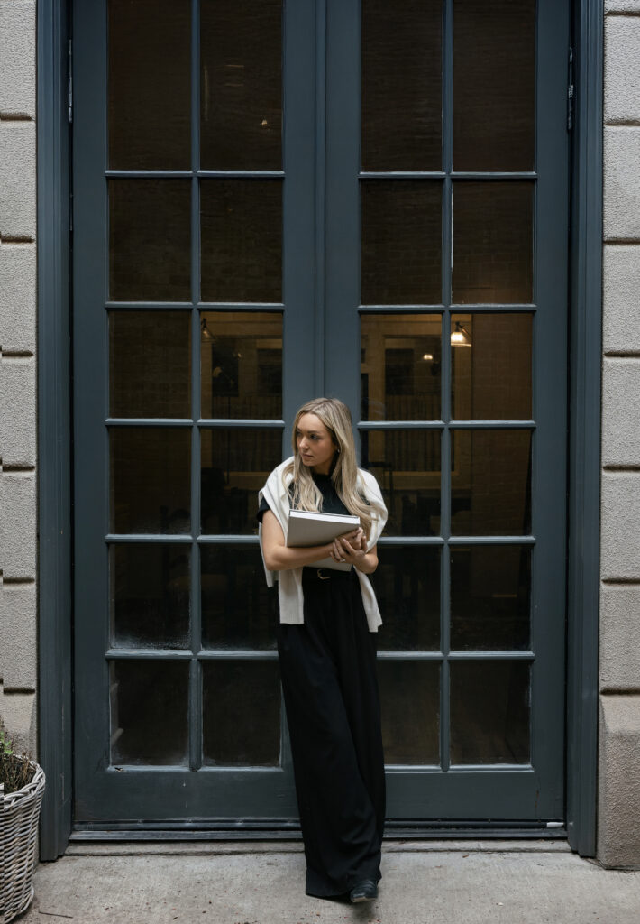 Two women holding side plank poses in stylish, color-coordinated athleticwear during a studio branding session for fitness instructors. Captured on a soft white and blush backdrop, this editorial-style portrait highlights strength, balance, and brand cohesion. Dani Lacey Photographs.