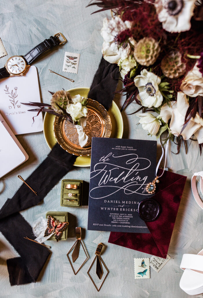 Wedding flat lay featuring heirloom accessories and the invitation suite, styled for detail shots during the wedding photo timeline. Dani Lacey Photographs.