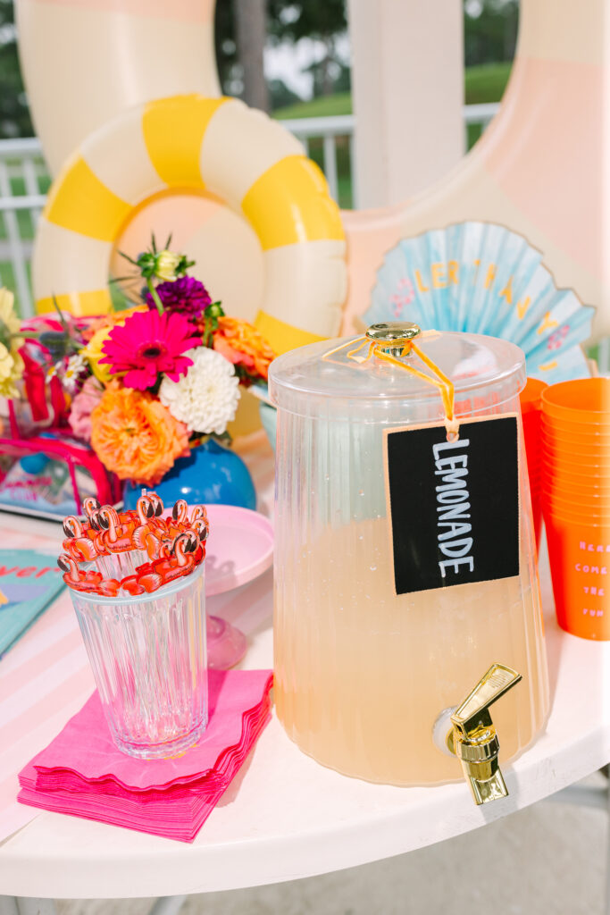 Poolside lemonade stand setup with flamingo stirrers and summer details — refreshing pool party style inspiration by Dani Lacey Photographs.