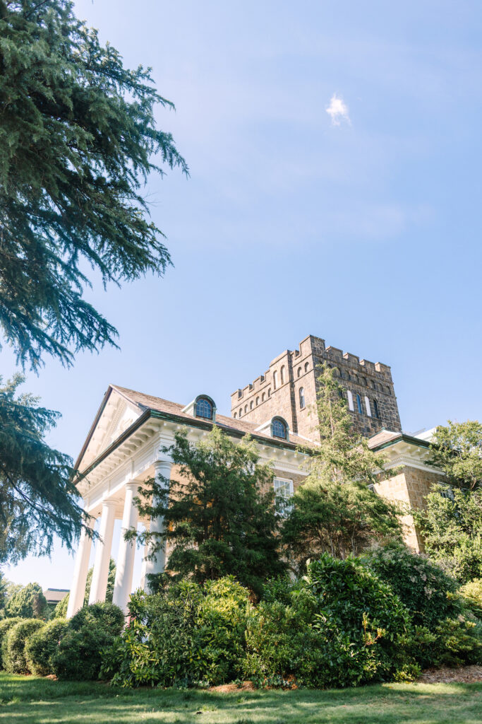 Exterior view of the historic Gassaway Mansion wedding venue in Greenville, South Carolina, with grand white columns, stone architecture, and lush greenery – Dani Lacey Photographs