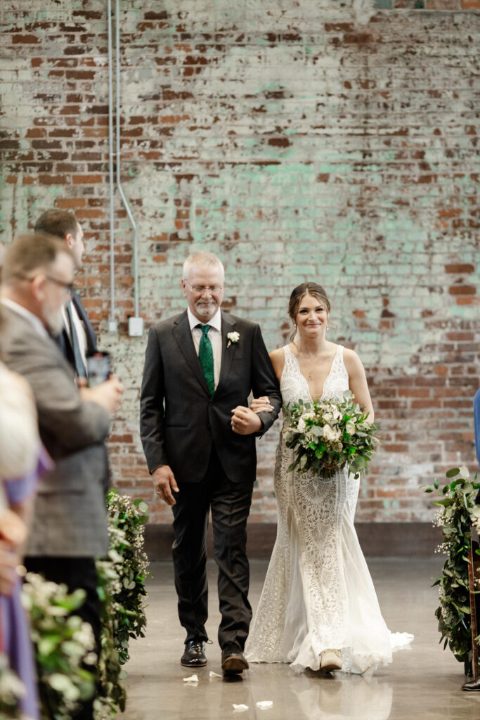 Bride walking down the aisle with her father at Judson Mill wedding ceremony in Greenville SC | Dani Lacey Photographs