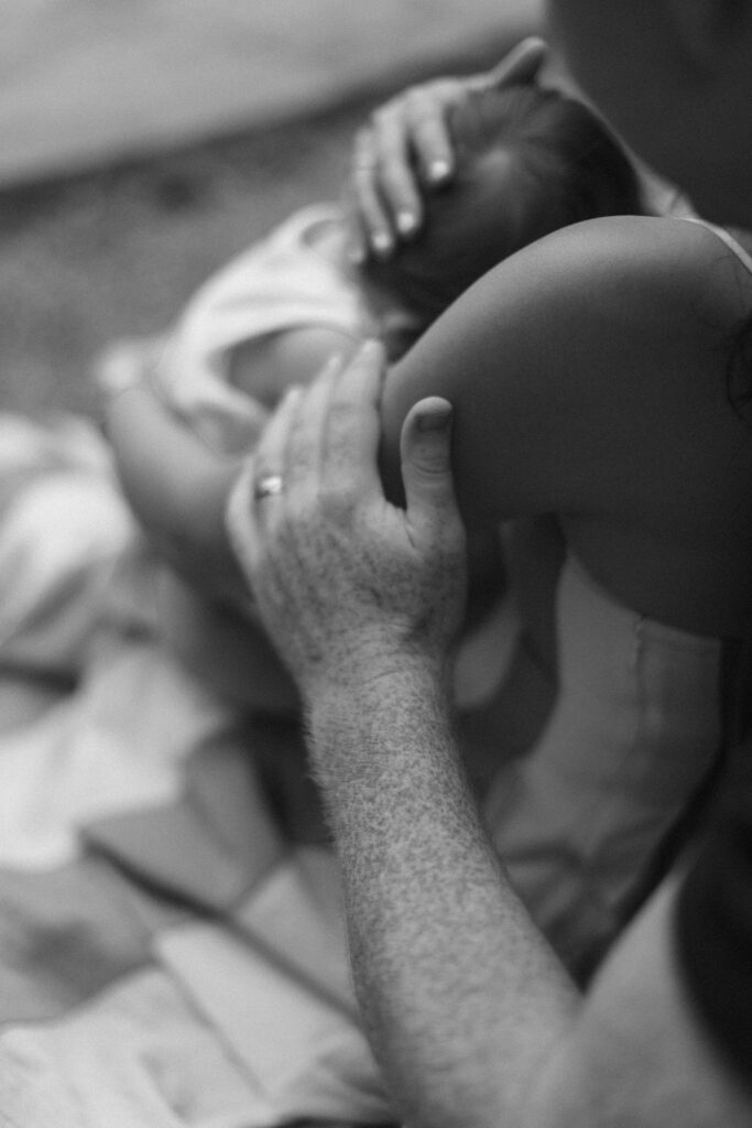 Black and white close-up of a family cuddling during Greenville SC Family Portraits at Furman University. Dani Lacey Photographs.