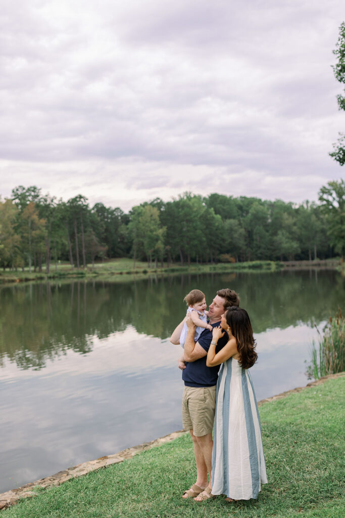 A family hugging by the lake at Furman University. Dani Lacey Photographs.
