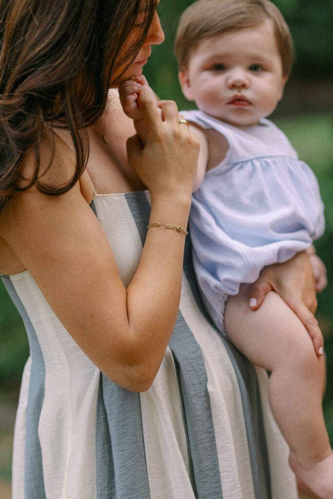 A mother holds her baby close during Greenville SC Family Portraits at Furman University. Dani Lacey Photographs.
