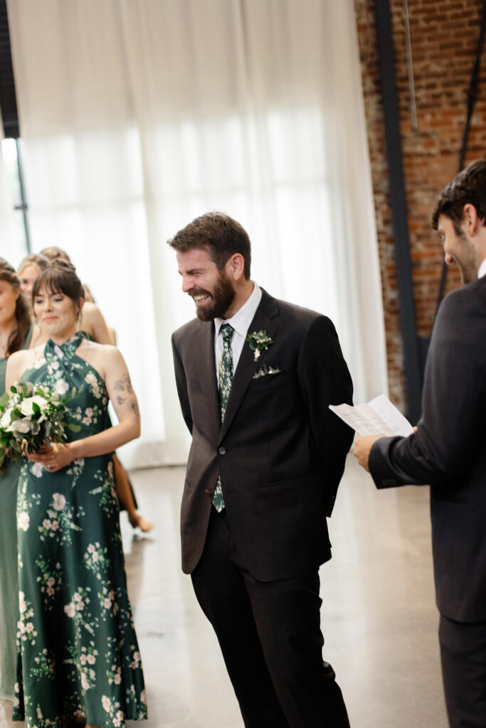Groom laughing during wedding ceremony vows at Judson Mill | Dani Lacey Photographs