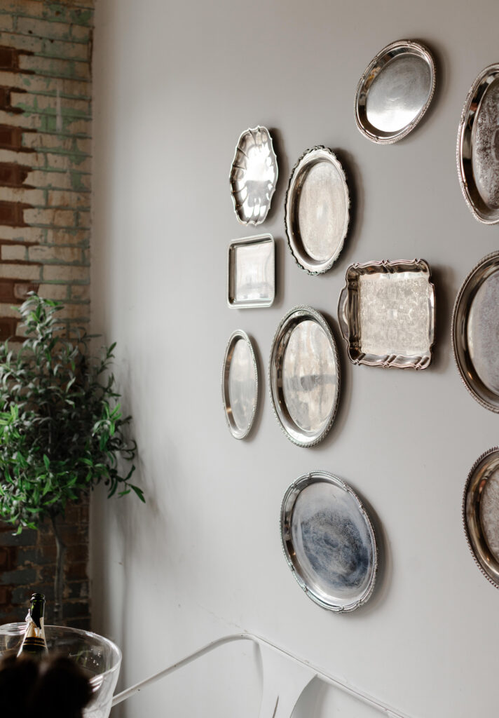 Vintage silver trays displayed on a wall at Judson Mill wedding venue in Greenville, SC, captured by Greenville wedding photographer Dani Lacey Photographs.