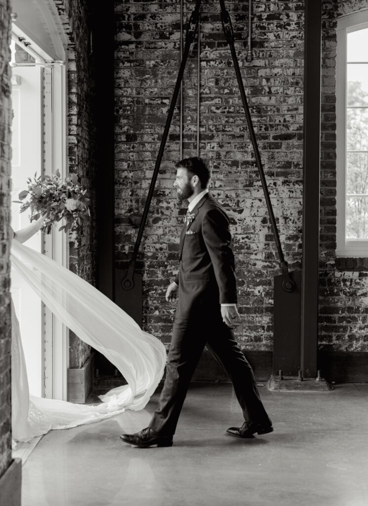 Bride and groom exiting ceremony with veil flowing at industrial Judson Mill wedding | Dani Lacey Photographs