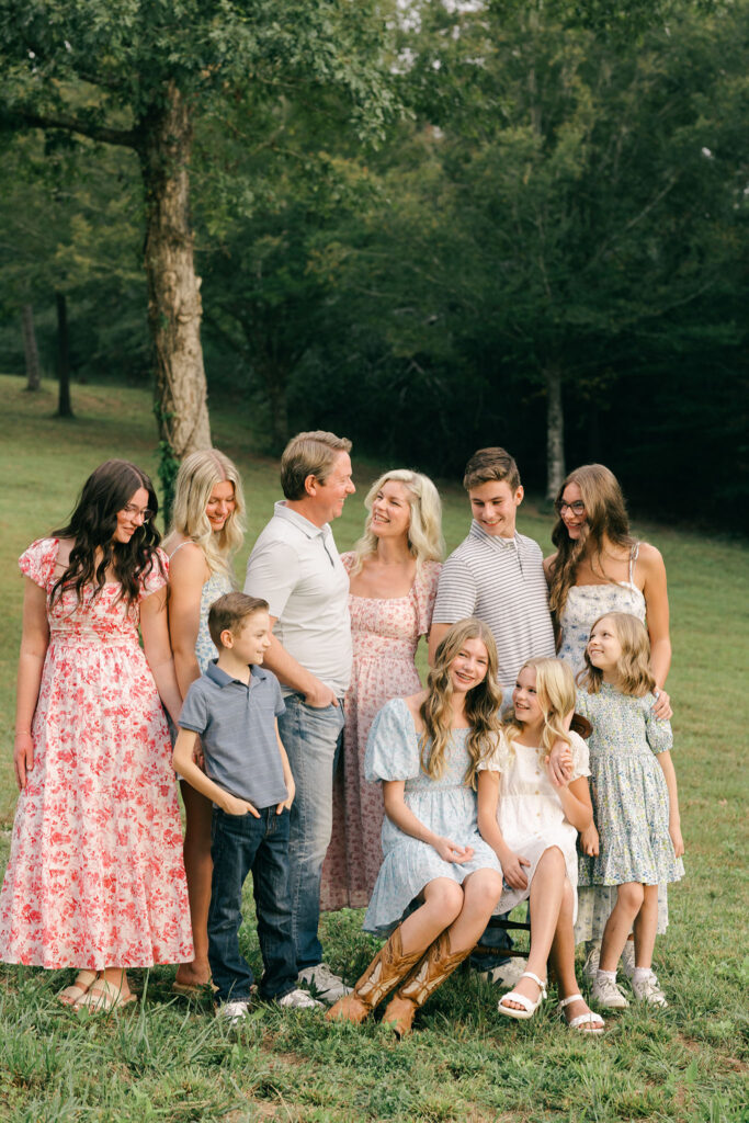 Smiling family gathered closely for a portrait during their at-home photo session in Greenville SC. Dani Lacey Photographs.