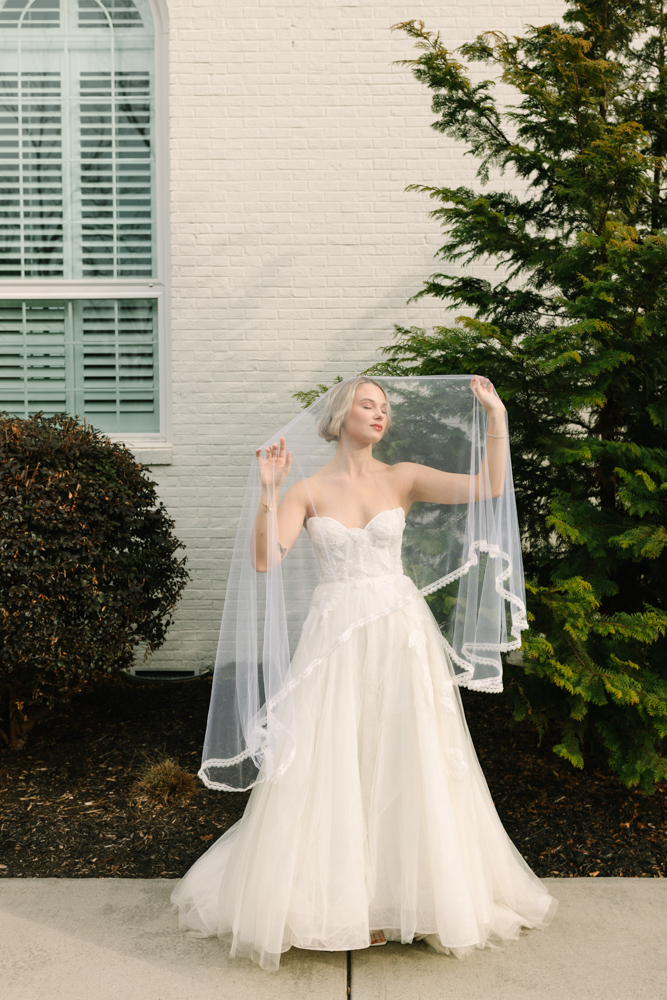 Bride lifting veil