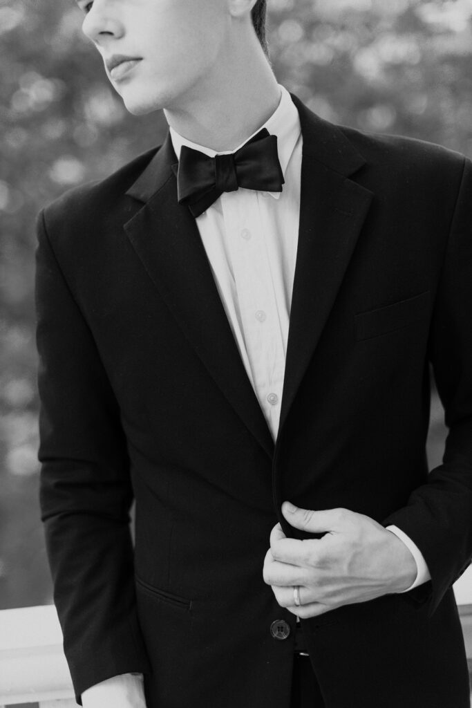 Groom wearing classic black tuxedo Why Niching Is Key in Photography