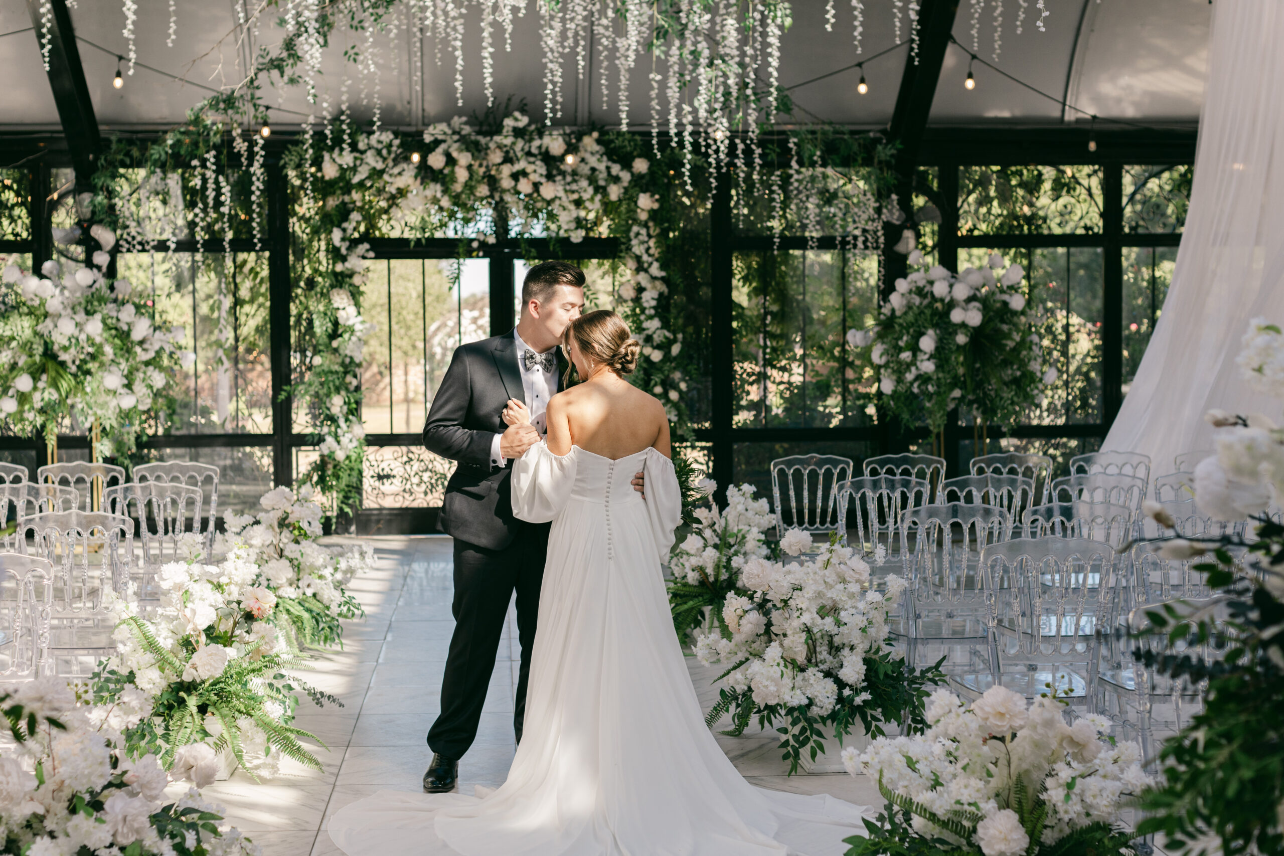 Couple standing together in conservatory aisle