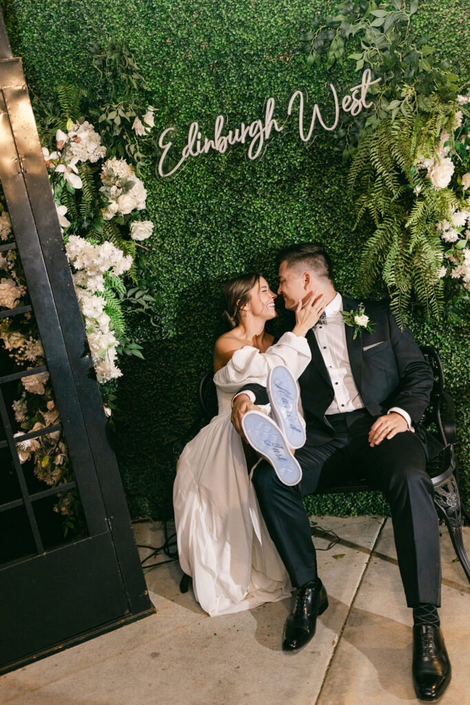 Couple seated beneath greenery wall Edinburgh West