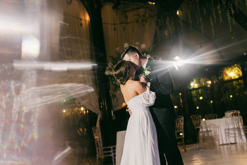 Couple kissing during night dance Edinburgh West wedding in Greenville