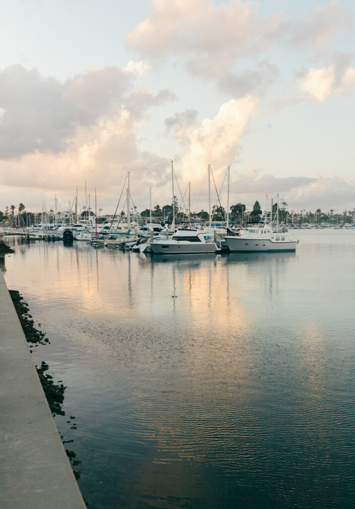 Sailboats resting in a harbor at sunset, photographed as wedding inspiration in South Carolina.