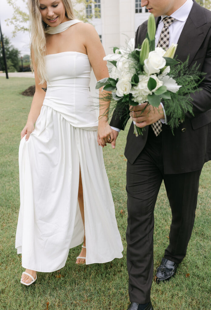 Bride and groom walking hand in hand during their wedding day in South Carolina, captured with natural movement and ease.