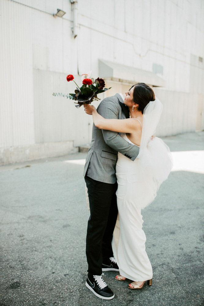 Inside An Editorial South Carolina Wedding Bride hugging groom outdoors
