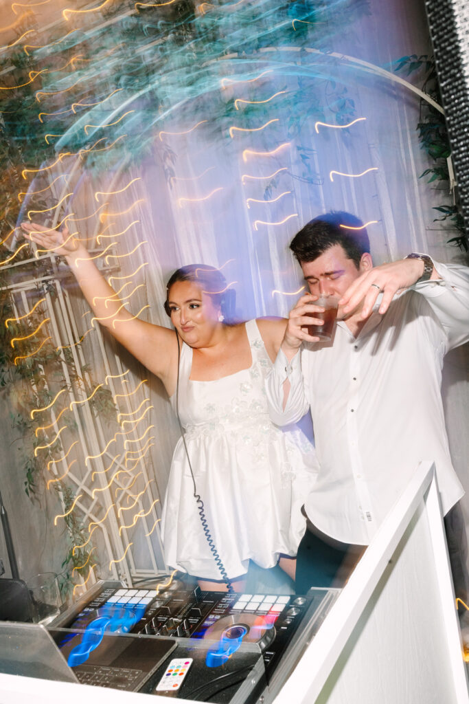 Couple dancing together under glowing lights during a wedding reception in South Carolina.