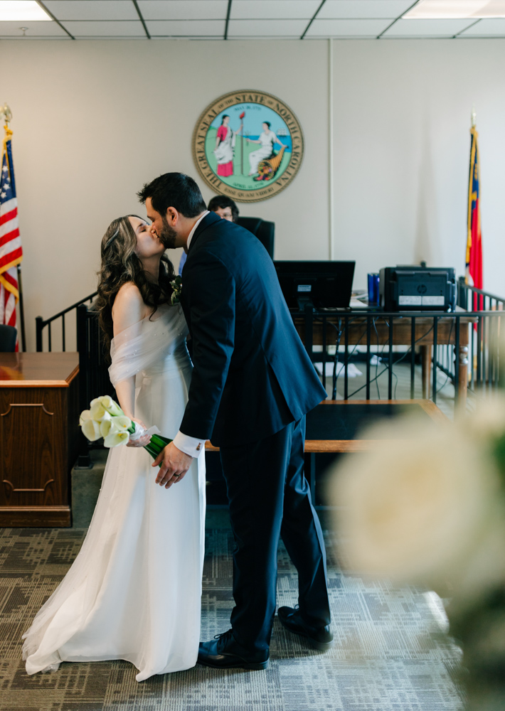 Couple kissing during courthouse ceremony