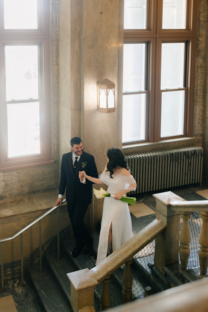 Couple walking down courthouse staircase in Downtown Asheville Wedding portrait
