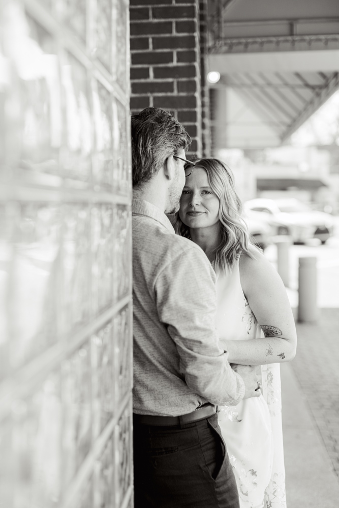 Couple standing outside downtown Clemson brick storefront
