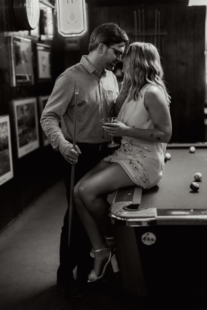 Couple leaning on pool table at Tiger Town Tavern Clemson