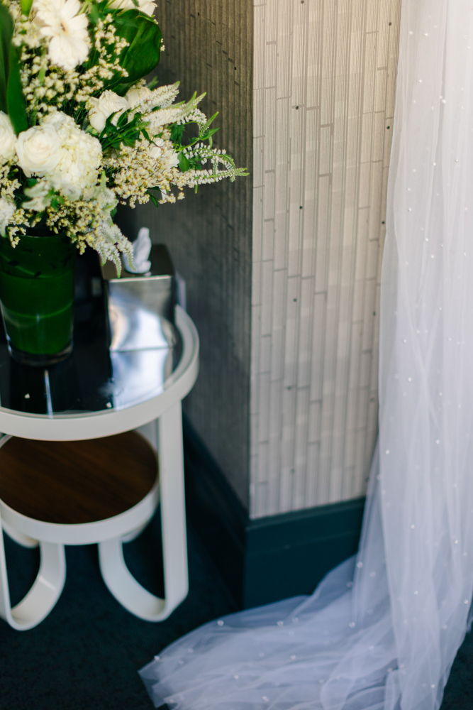 Bridal bouquet beside veil detail