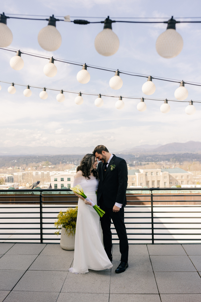 Couple under rooftop string lights
