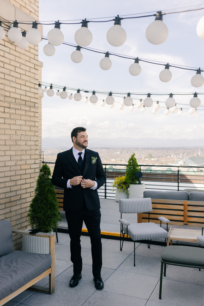 Groom portrait on rooftop terrace