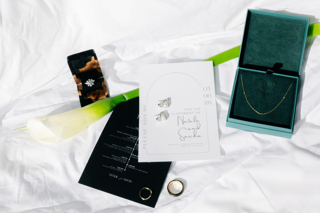 Elopement details and jewelry flatlay