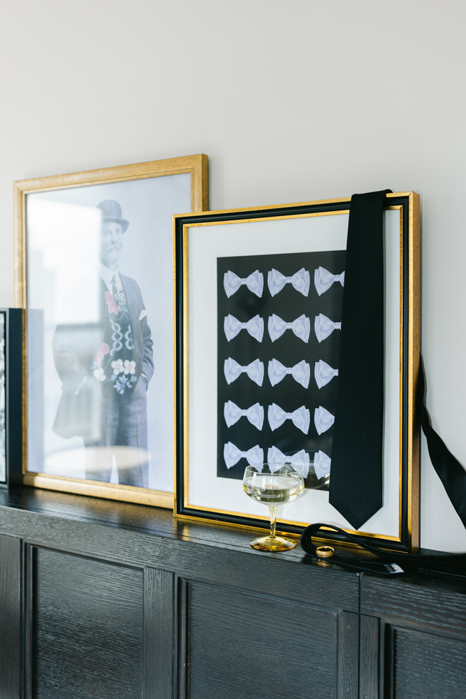 Groom tie and ring styled on framed art