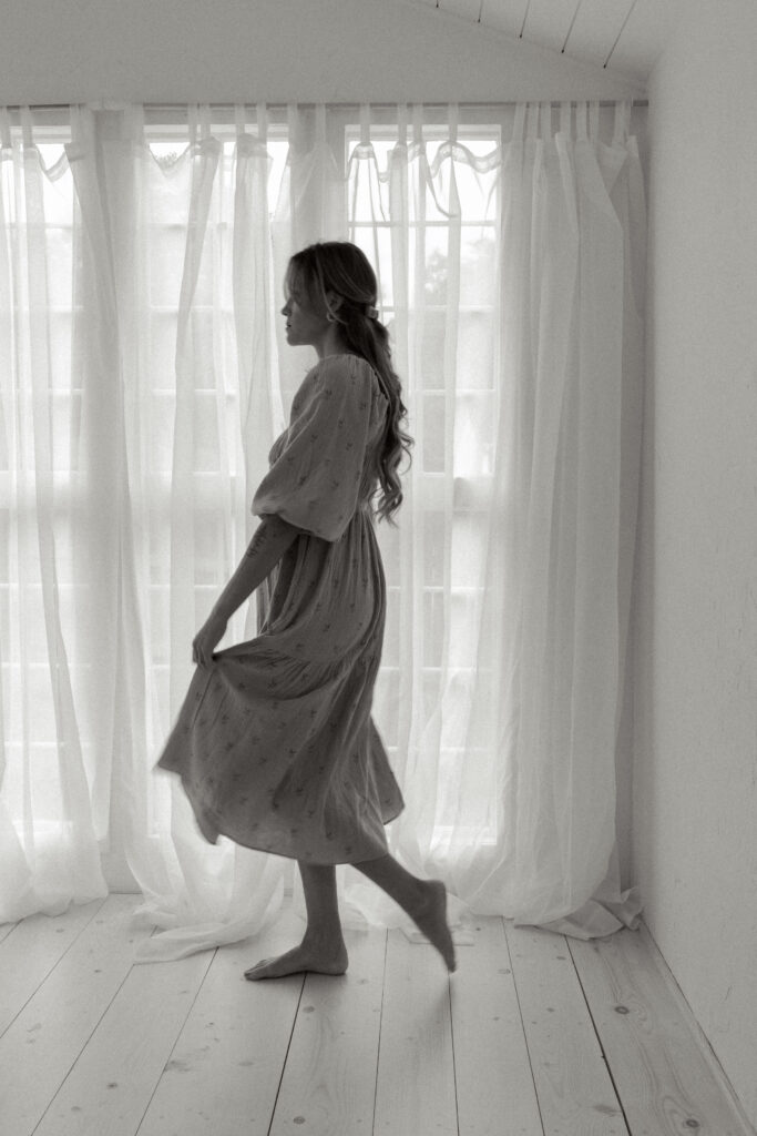 woman walking window light studio