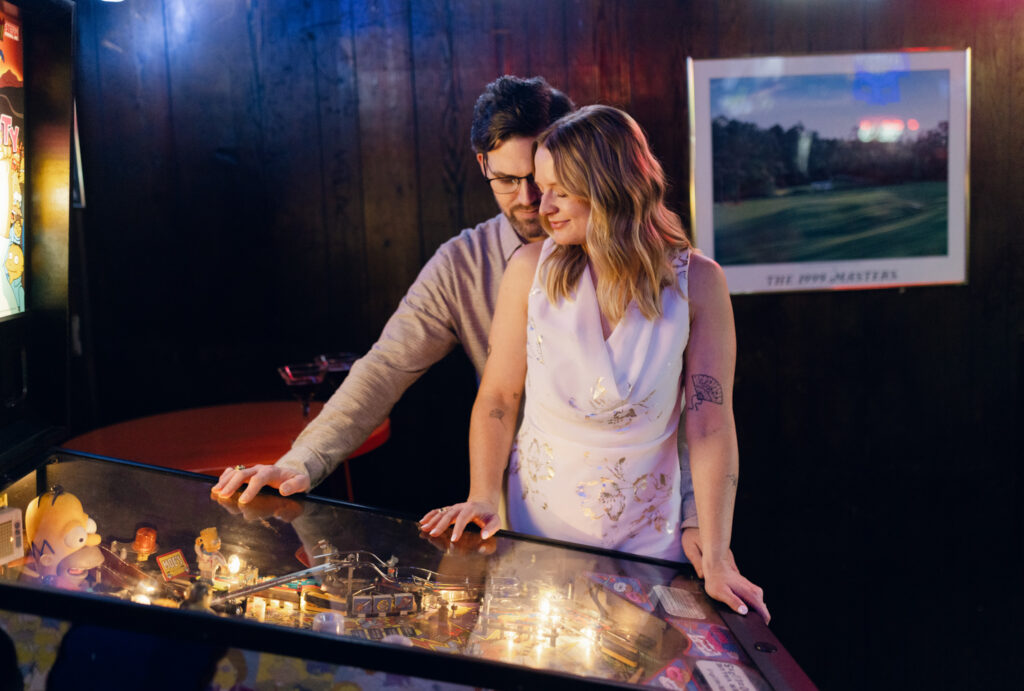 Couple playing arcade game during Clemson engagement session