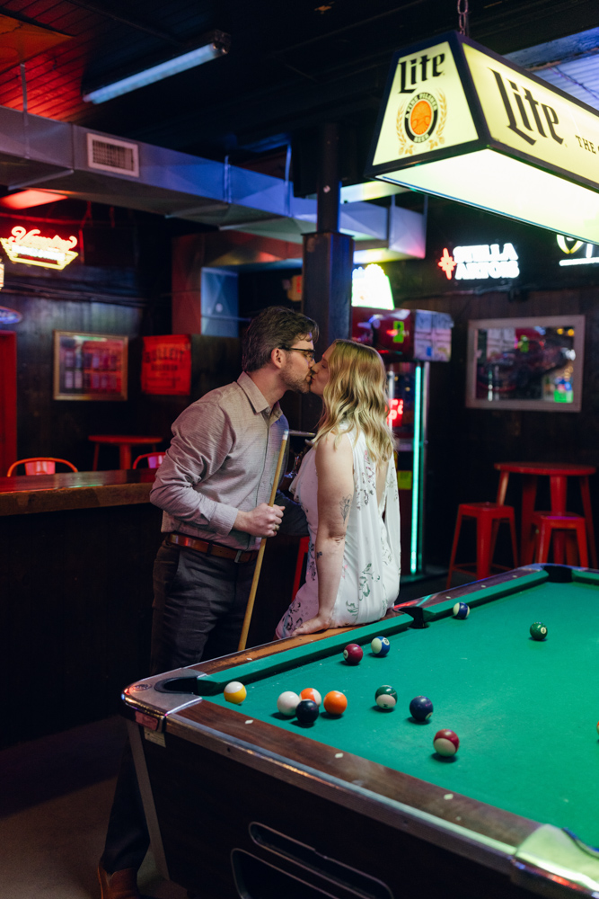 Couple kissing beside pool table at Clemson tavern