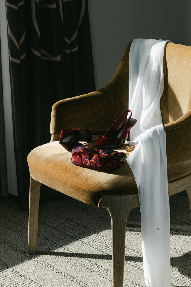 Wedding shoes and veil on hotel chair