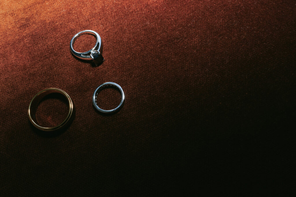Wedding rings on dark textured fabric
