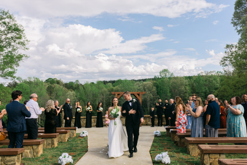 Bride and groom walking down ceremony aisle