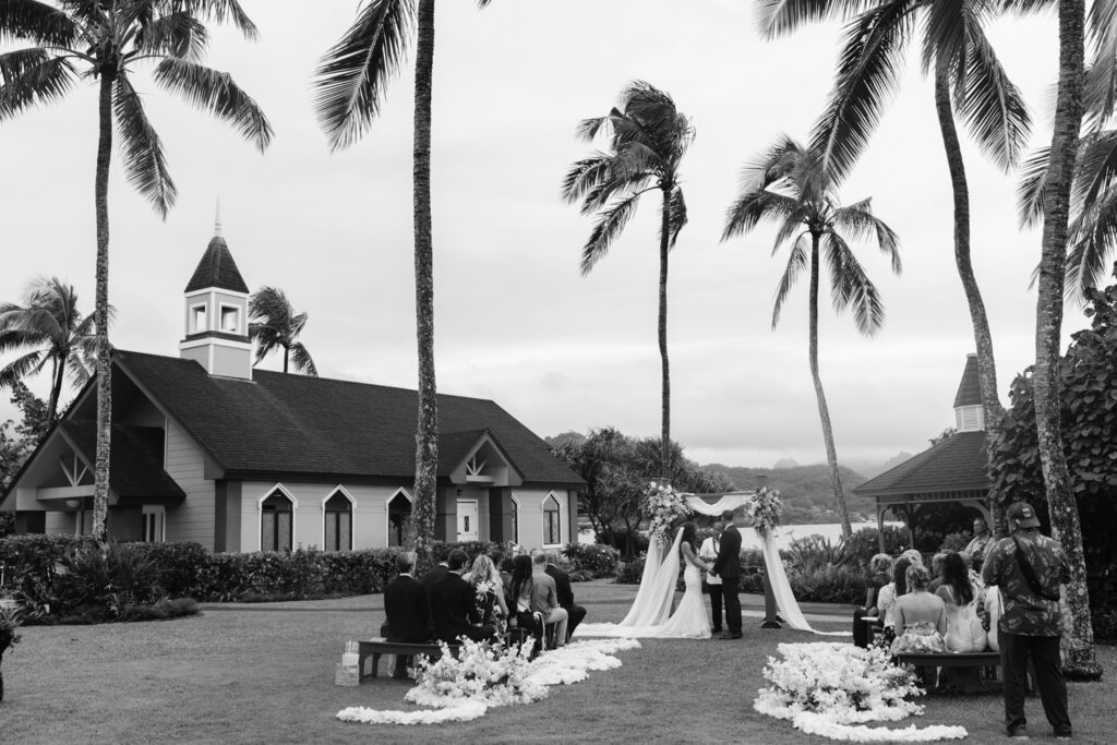 Outdoor wedding ceremony beneath tropical palms