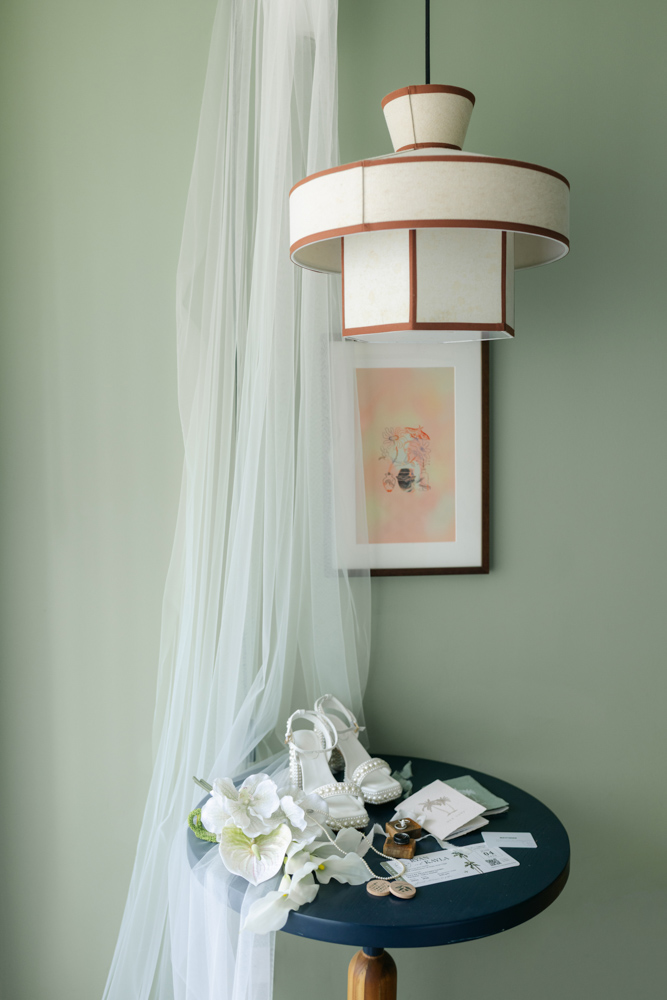 Wedding details with veil, shoes, florals and invitation