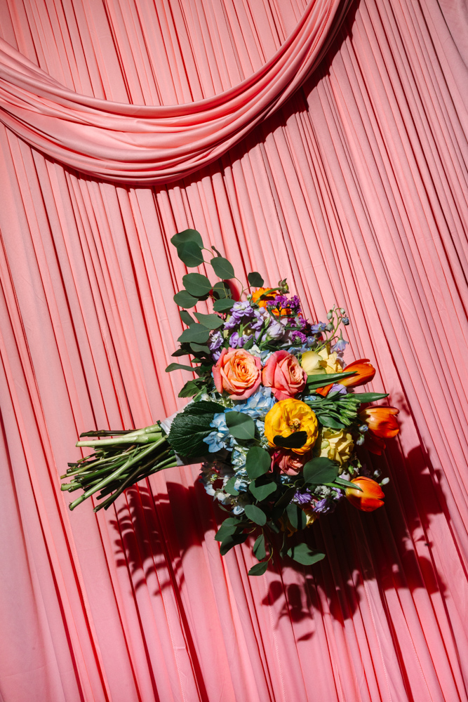Colorful bridal bouquet on pink backdrop