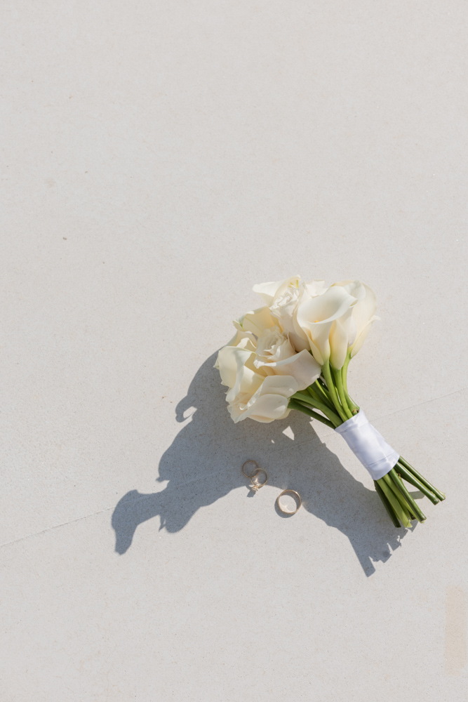 Bridal bouquet and wedding rings on courthouse steps
