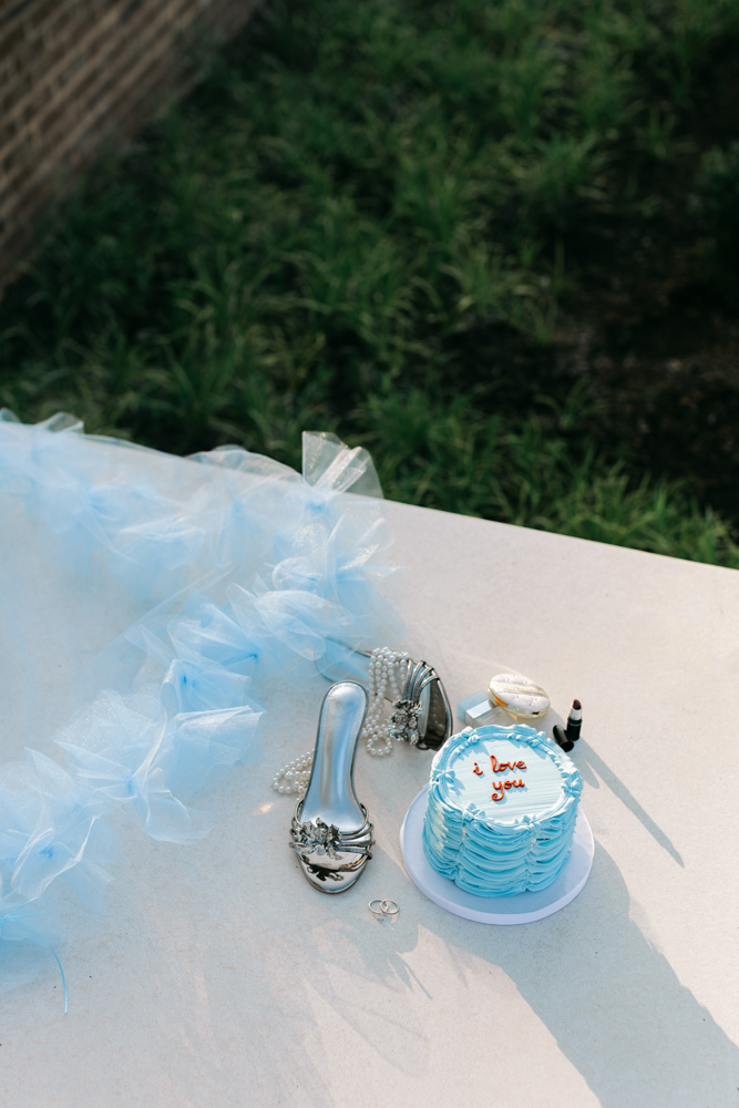 Blue bridal details with cake and silver heels
