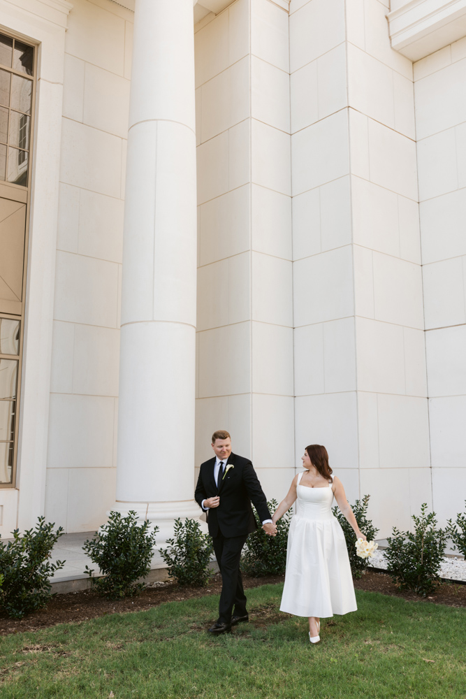 Bride and groom walking outside the Spartanburg County Courthouse