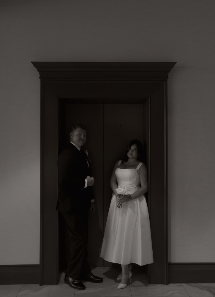 Black and white portrait of newlyweds at courthouse elevator