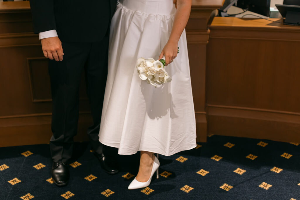 Bride holding bouquet next to the groom inside the courtroom in Spartanburg County.